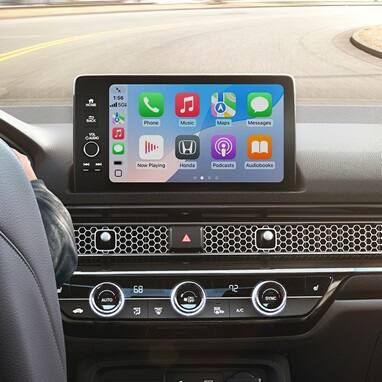 2026 Honda Civic Hatchback Sport Touring Hybrid dashboard with screen displaying Apple CarPlay (Compact Hatchback).