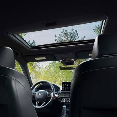 2026 Honda Civic Hatchback Sport Touring Hybrid interior detail of the power moonroof and overhead console (Compact Hatchback).