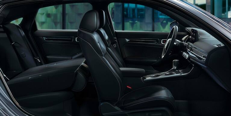 2026 Honda Civic Hatchback Touring Hybrid leather-trimmed seats with rear seat folded down (Compact Hatchback).