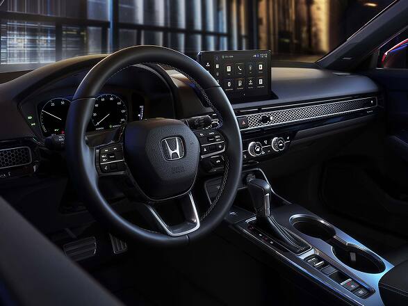2026 Honda Civic Hatchback Sport Touring Hybrid interior dashboard, steering wheel, and digital infotainment screen (Compact Hatchback).
