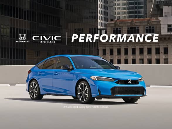 2026 Honda Civic Hatchback Sport Touring Hybrid in Boost Blue Pearl profile on a rooftop parking lot with city buildings (Compact Hatchback).